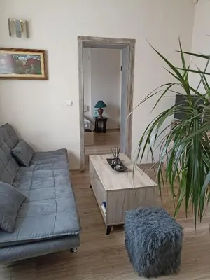 a living room with a couch and a coffee table at Приятелската къща in Velingrad