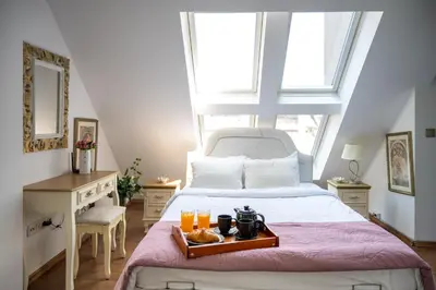 a bedroom with a bed with a tray of food on it at Sunny Studio with a view in TOP Center in Sofia