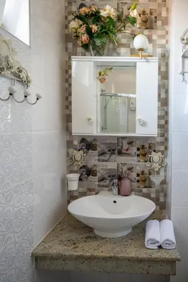 a bathroom with a sink and a mirror at Sunny Studio with a view in TOP Center in Sofia