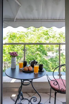 a table with a plate of food on it in front of a window at Sunny Studio with a view in TOP Center in Sofia