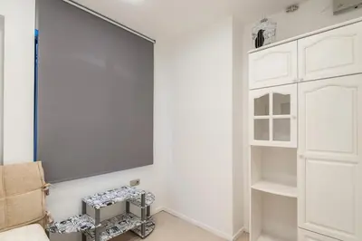 a living room with a tv and white cabinets at Top Center Apartment next to Vitosha Boulevard in Sofia