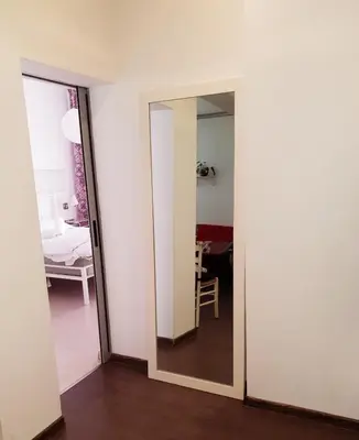 an open door to a room with a mirror at Top Center Apartment next to Vitosha Boulevard in Sofia