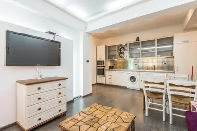 a living room with a flat screen tv on a wall at Top Center Apartment next to Vitosha Boulevard in Sofia