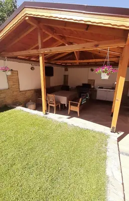 a pavilion with a table and a couch under it at Къща за гости Чечев in Sapareva Banya