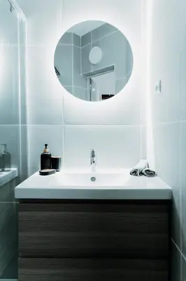 a bathroom with a sink and a mirror at Magnificent apartment in the mountains in Banite