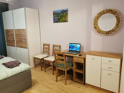 a bedroom with a desk with a laptop on it at Rila Apartment in Sofia