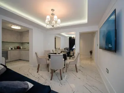a dining room and living room with a table and chairs at Paradise Center Premium Suite 2 in Sofia