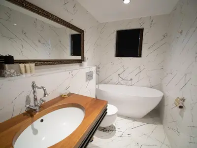 a bathroom with a sink and a tub and a toilet at Paradise Center Premium Suite 2 in Sofia