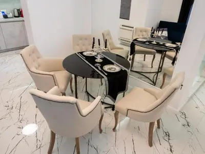 a dining room with a black table and chairs at Paradise Center Premium Suite 2 in Sofia