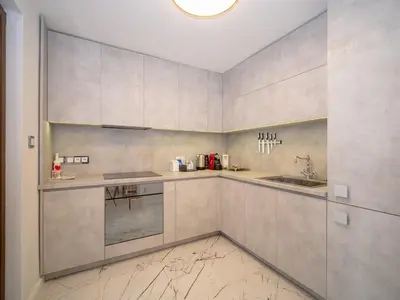 a kitchen with white cabinets and a sink at Paradise Center Premium Suite 2 in Sofia