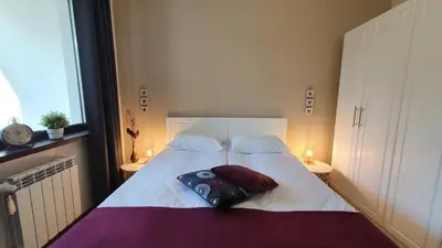 a bedroom with a bed with a pillow on it at Borovets Holiday Homes in Borovets