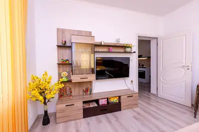a living room with a large entertainment center at Къща за гости Калинови in Sandanski