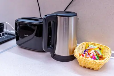 a toaster and a basket of candy on a counter at Къща за гости Калинови in Sandanski