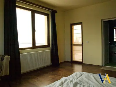 an empty room with a bed and two windows at Villa Aya in Smochevo
