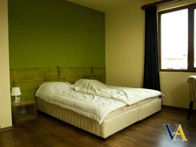 a bed in a room with a green wall at Villa Aya in Smochevo