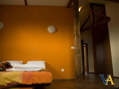 a bed in a room with an orange wall at Villa Aya in Smochevo