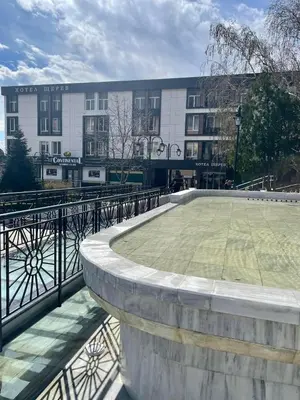 a large building with a courtyard in front of it at Hotel Shterev Karlovo in Karlovo