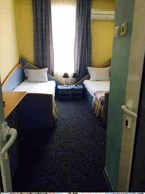 a hotel room with two beds and a window at Hotel Shterev Sopot in Sopot