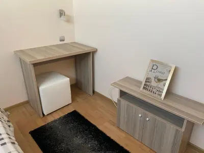 a room with a desk and a table with a book at Апартамент за гости Dolce Vita in Gyurgevo