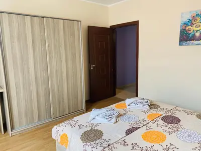 a bedroom with a bed in a room with a door at Апартамент за гости Dolce Vita in Gyurgevo