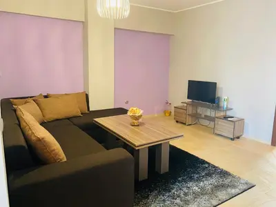 a living room with a couch and a table at Апартамент за гости Dolce Vita in Gyurgevo