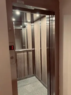 a wooden elevator door in a room with a mirror at Апартамент за гости Dolce Vita in Gyurgevo