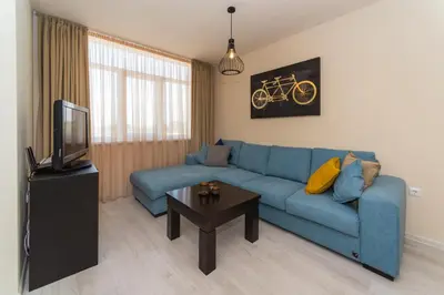 a living room with a blue couch and a tv at Alma Apartment - Stylish 1BD Flat with Balcony by Flat Mаnager in Plovdiv