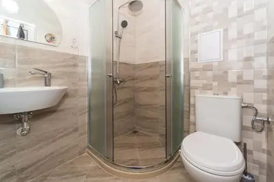 a bathroom with a shower and a toilet and a sink at Alma Apartment - Stylish 1BD Flat with Balcony by Flat Mаnager in Plovdiv