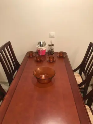 a wooden table with two chairs and a bowl on it at Luxury Downtown Apartment - Gondola in Bansko