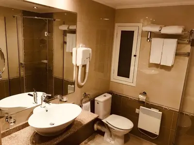 a bathroom with a sink and a toilet and a mirror at Luxury Downtown Apartment - Gondola in Bansko