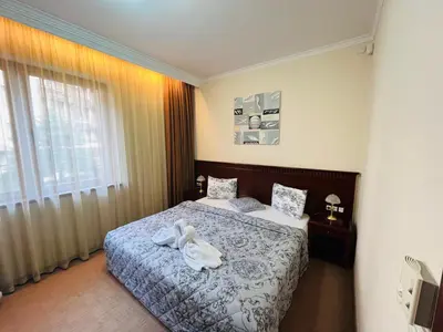 a bedroom with two beds and a window at Luxury Downtown Apartment - Gondola in Bansko