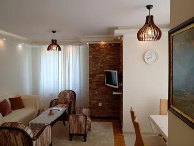 a living room with a couch and a table at Valentina Bg Apartment in Sofia