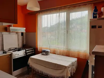 a small kitchen with a table in front of a window at Apartment Milevi in Teteven