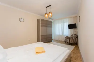 a bedroom with a white bed with a towel on it at Apartment 