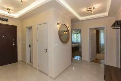 a hallway of a home with a mirror on the ceiling at Apartment 