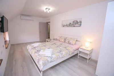 a small bedroom with a bed and a night stand at The Sun loves You - right beside the Park! in Sandanski