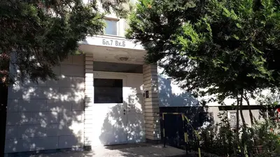 a white building with a door with a sign on it at 2 Bedrooms with private Bath and balcony near the Airport in Sofia