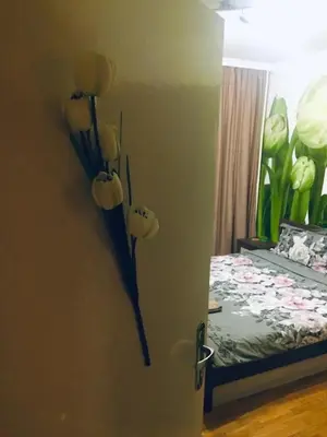 a door with flowers on the wall next to a bed at 2 Bedrooms with private Bath and balcony near the Airport in Sofia