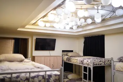 a room with three bunk beds and a chandelier at Hostel Plovdiv in Plovdiv
