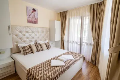 a bedroom with a large bed with two towels on it at Park Apartment Emilin in Sandanski