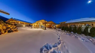 a snow covered driveway in front of a house at Mountain Hawk Park in Bansko