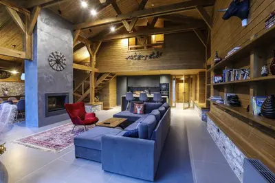 a living room with a blue couch and a red chair at Mountain Hawk Park in Bansko