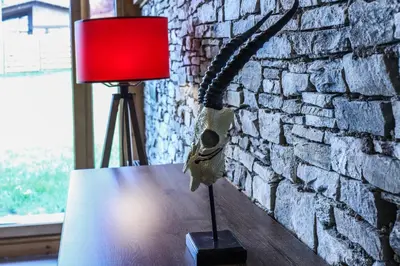 a lamp sitting on a table next to a brick wall at Mountain Hawk Park in Bansko