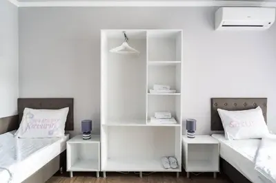 two beds in a room with white shelves at Elegance, City center, Kapana in Plovdiv