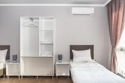 a bedroom with two beds and a book shelf at Elegance, City center, Kapana in Plovdiv