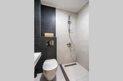 a bathroom with a toilet and a shower at Elegance, City center, Kapana in Plovdiv