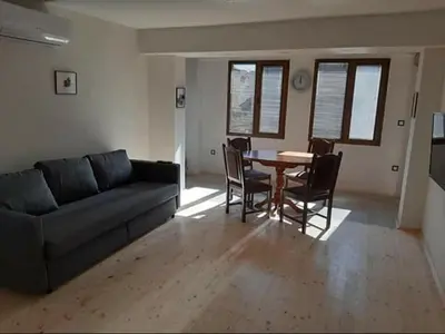 a living room with a couch and a table and chairs at Родопчани Старцево in Starzewo