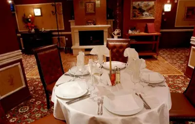a dining room with a table with a white table cloth at Private Apartment in Grand Monastery in Pamporovo