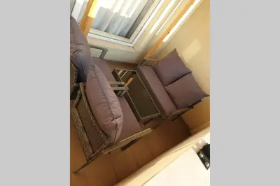 three empty chairs in a room with a window at Cosy Charming Apartment in Blagoevgrad