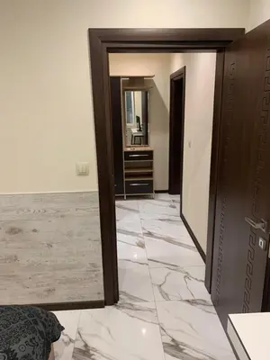 a hallway with marble floors and a mirror at Патилови in Sandanski